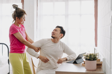 Fototapeta premium Asian wife asking husband to stop working and watching with computer tablet.