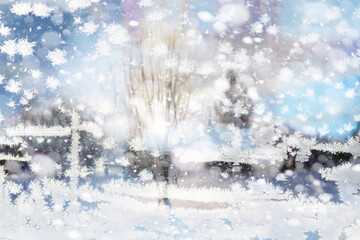 Winter landscape through a frozen window. Blurred snow background. Trees and plants covered with snow.