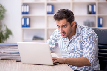 Young male employee working in the office