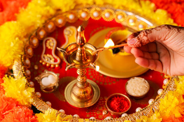 Onam Diwali vishu celebration Indian festival flowers marigold flowerbed lighted oil lamp Nilavilakku Diya colors Rangoli decoration greetings Dipavali Kerala Tamil nadu North India Mumbai Delhi India