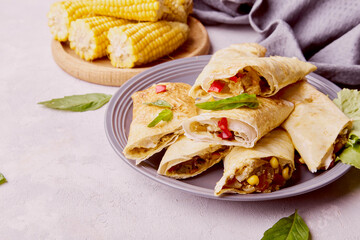 Southwest Chicken Egg Rolls combination of corn, black beans, red bell peppers, jalapenos, shredded cheese chicken with sweet and spicy seasoning in an egg roll wrapper.