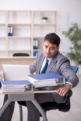 Young male employee working in the office