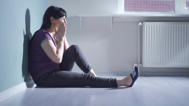 Woman slapping herself with a nervous breakdown.