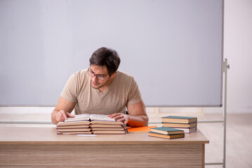 Young male student sitting in the classroom