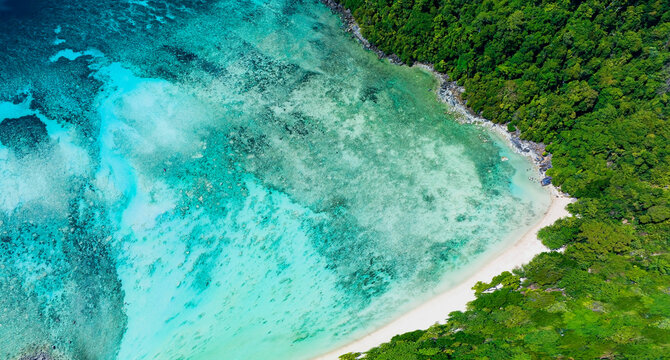 Aerial view with The tropical seashore island in a coral reef ,blue and turquoise sea Amazing nature landscape with blue lagoon © SASITHORN