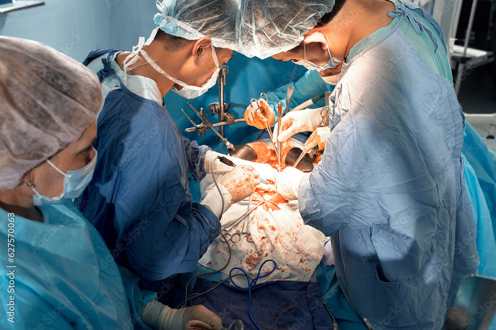 Aufkleber top view of surgeons team during complex surgical operation in a bright sterile operating room. doct