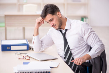 Young male employee working in the office