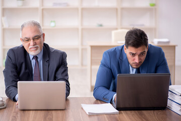 Two male employees working in the office