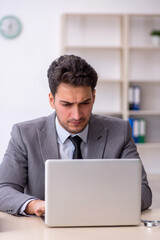 Young male employee working in the office
