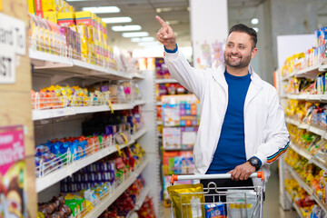 Young indian man shopping at grocery store.
