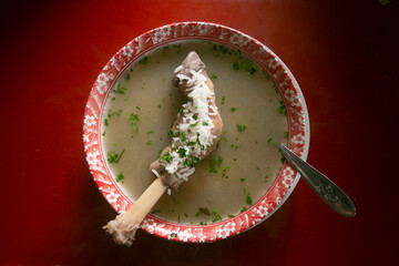 Caldo de cordero is a traditional soup from the city of Cusco in Peru. It is served with rice, lamb...