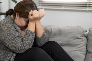 Sad Overweight plus size woman thinking about problems on sofa upset girl feeling lonely and sad from bad relationship or Depressed woman disorder mental health.