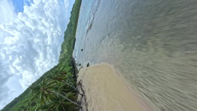 Cinematic racing drone flight on the tropic coastline of the Dominican republic