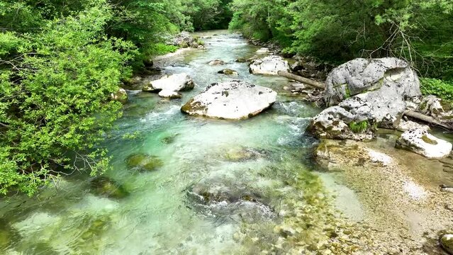 Aerial Drone Fly Slow Above Turquoise Water Flow Stream Between Lush Forest in Logar Valley, Slovenia Travel and Tourism