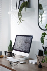 Cozy workspace with computer on wooden desk at home