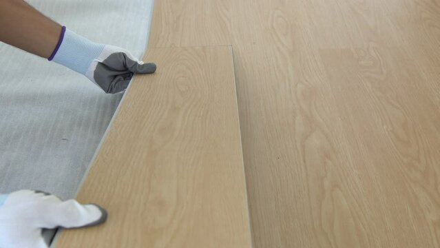 flooring installation and renovation. spc (Stone Plastic Composite) wooden texture surface. interior wooden flooring material