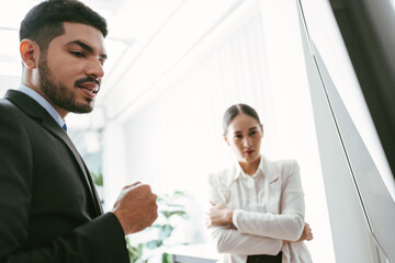 Asian professional successful businessman pointing stock or crypto graph on the monitor screen while meeting. Stock or crypto trade information graph chart showing on a monitor screen.