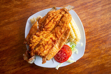 Chicharron de trucha. Traditional Andean recipe in Peru of fried trout served with cassava and...