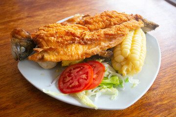 Chicharron de trucha. Traditional Andean recipe in Peru of fried trout served with cassava and...