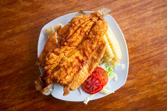 Chicharron de trucha. Traditional Andean recipe in Peru of fried trout served with cassava and salad.