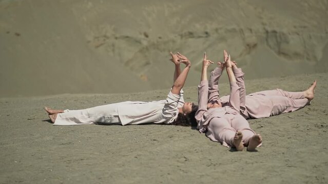 many female hands. female hands. slow motion video. three women lie on the sand. Full HD video recording