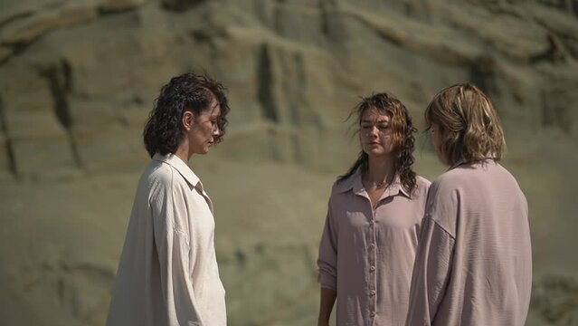 three women are hugging. close-up of hugs. three women in the desert. slow motion video. High quality Full HD video recording