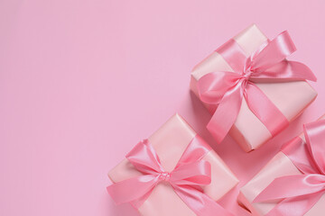 Beautiful gift boxes on pink background, flat lay. Space for text