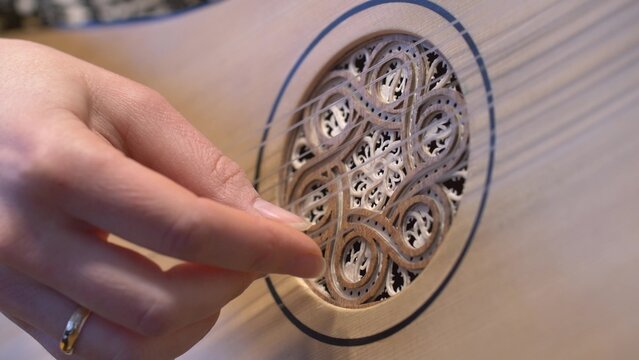 Female Guitarist Playing Song on Baroque Guitar Replica Close Up