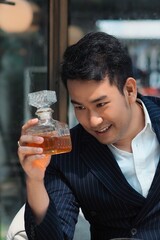 man drinking a glass