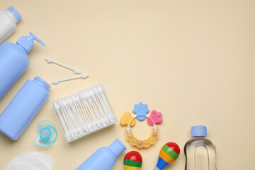 Flat lay composition with baby care products and accessories on beige background, space for text