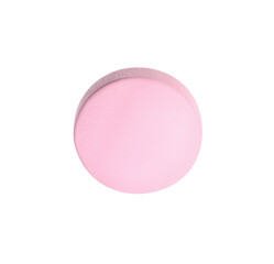 One pink pill on white background. Medicinal treatment