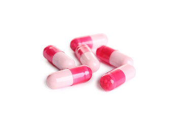 Many pink pills isolated on white. Medicinal treatment
