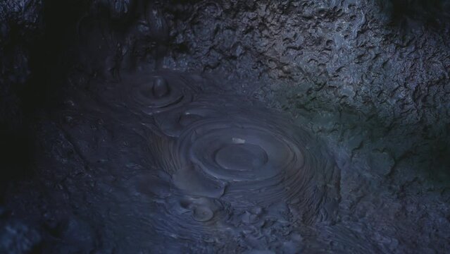 Boiling hot geothermal volcanic mud pool, closeup shot steamy lake bubbling mud and steam satisfying