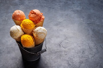 Assorted ice cream flavours in delightful waffle cones © evgeeenius
