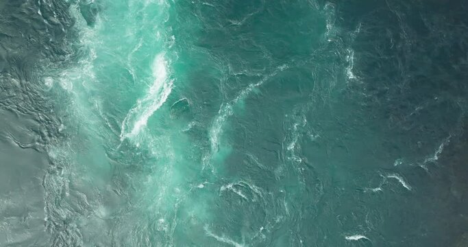 Azure blue Saltstraumen maelstrom current with spinning vortex and whirlpools