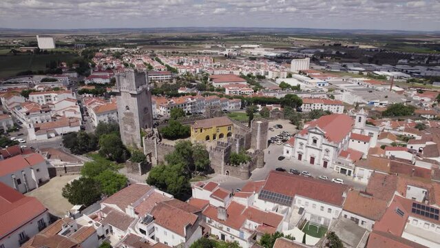 Castle Beja old defensive tower aerial view circling Baixo Alentejo whitewashed red tiled rooftops, Portugal cityscape
