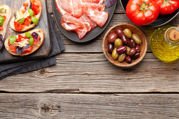 Italian cuisine. Prosciutto and antipasto toasts