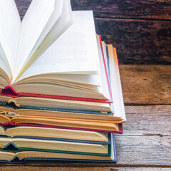 vintage opened books on a wooden background and space for text