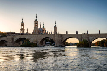 Arched Bridge Over River Sunset