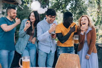 friends having fun at party with beer and food