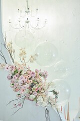 Staircase decor with transparent balls and flowers. Festive interior.