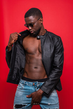 Confident black macho man with unbuttoned jacket