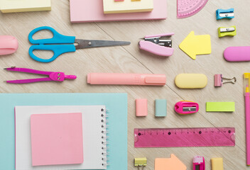 Flat lay with colorful school stationery on wooden backgroung, top view