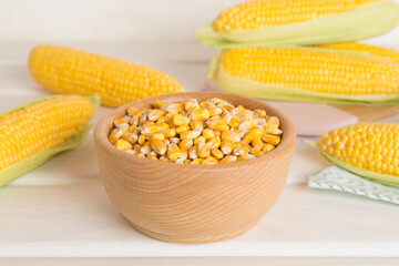 Dry corn with fresh cobs on wooden table