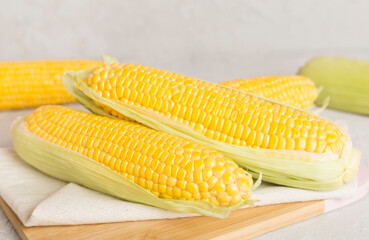 Fresh corn on cobs on wooden table
