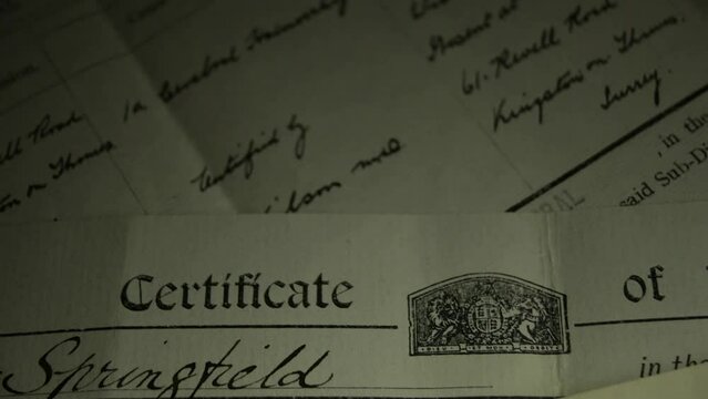 Slow panning shot of Genealogy documents - British birth, marriage and death certificates