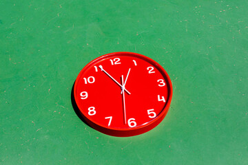 Red clock in green background