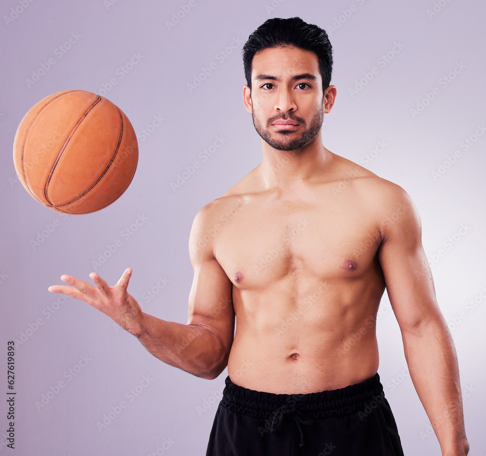 Poster Portrait, sports and basketball with a man in studio on a gray background for training or a game. Exercise, workout or mindset and a confident young male athlete with a ball for a competitive hobby