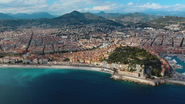 Aerial view of Nice City Promenade Beach and Mediterranean Sea in Cote d'Azur, France. Seaside luxury resort town on the French Riviera with turquoise sea and beautiful panoramic city landscape 4K