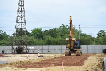bull dozer in construction site with derrick pole